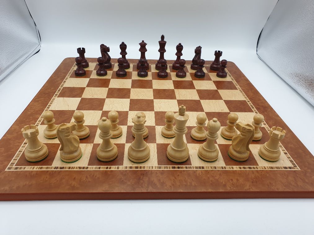 Elmwood chessboard with red stained pieces