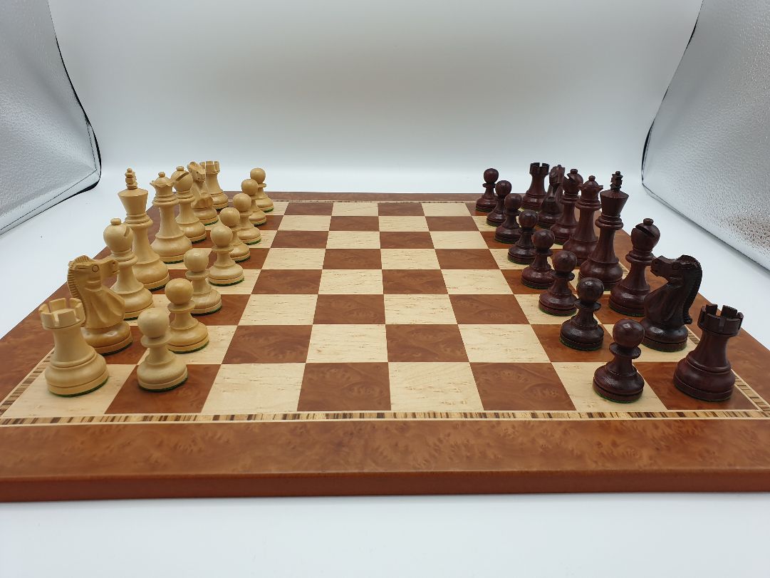 Elmwood chessboard with red stained pieces